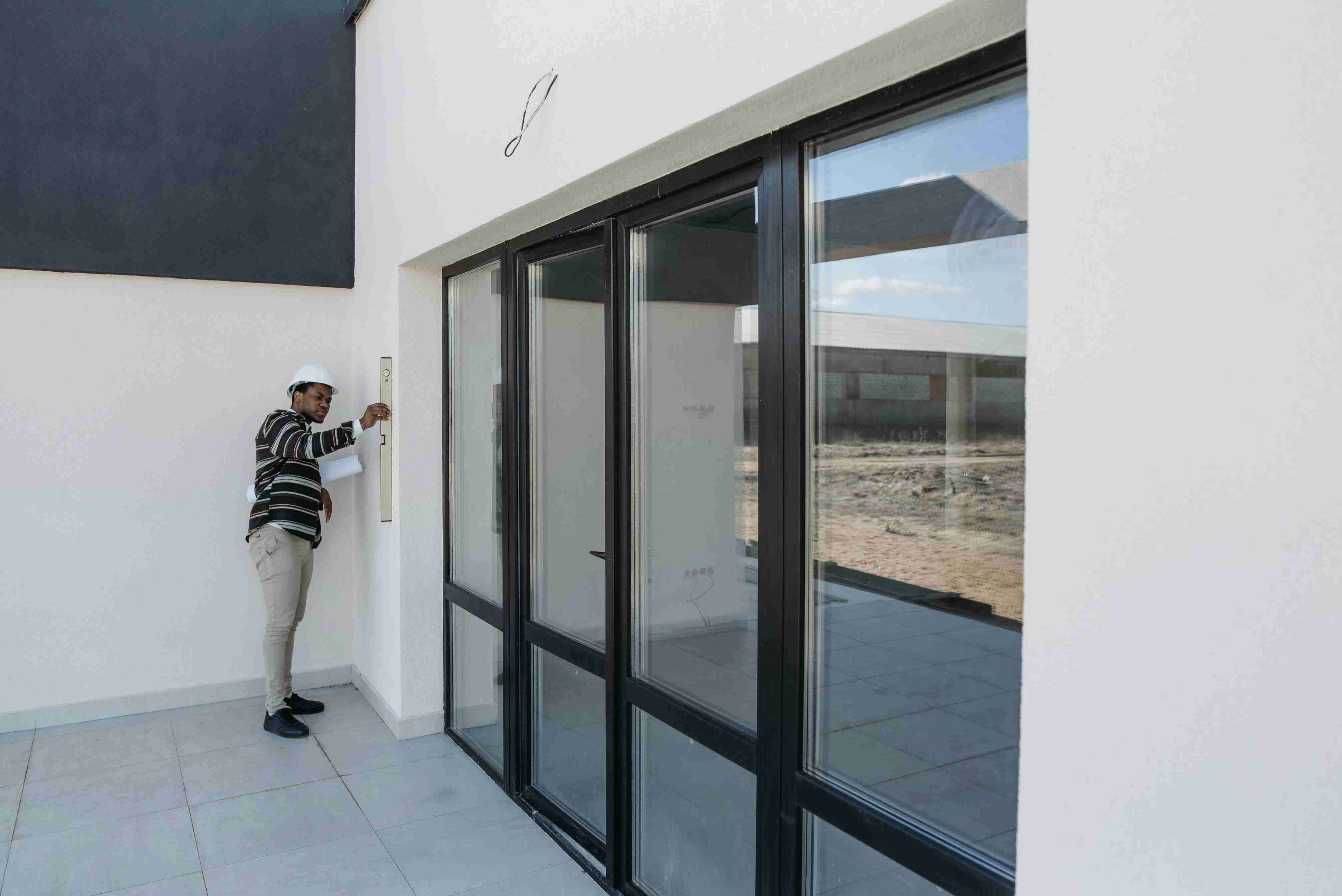 Installer measuring a residential window during an insulation site assessment